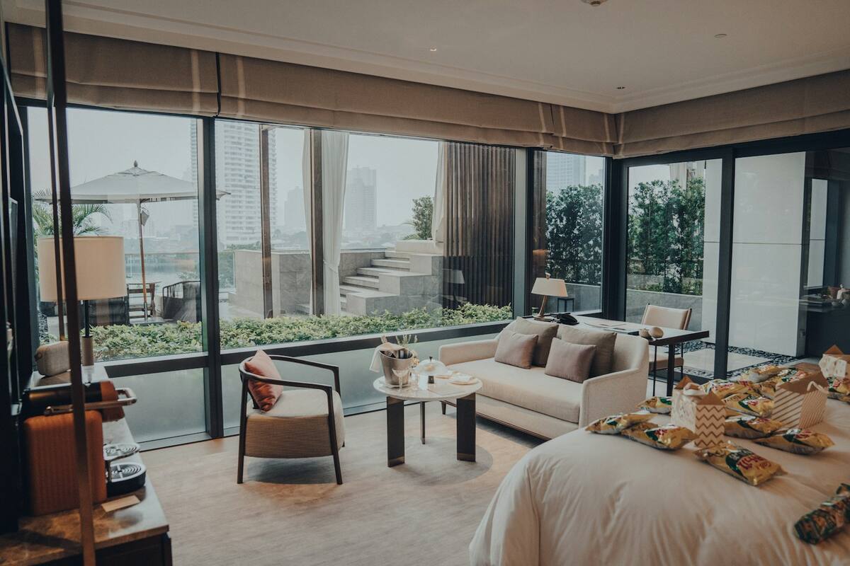 A bright boutique hotel suite with floor-to-ceiling windows